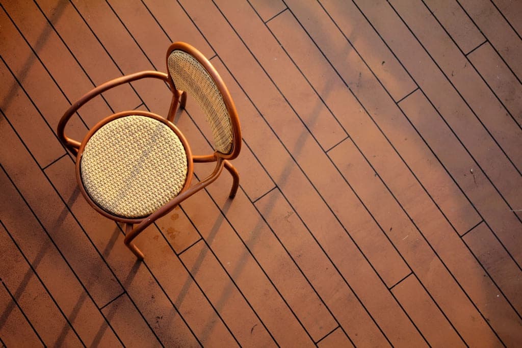 Close detail of rich hardwood flooring laid on the diagonal.